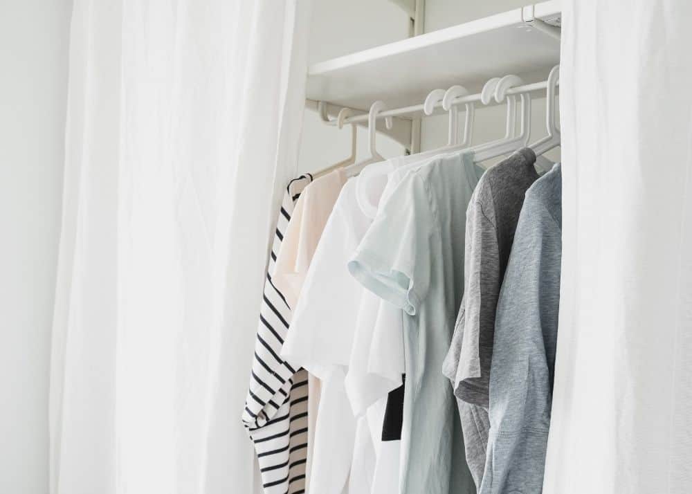 capsule wardrobe for toddlers with basic tops on hangers in closet