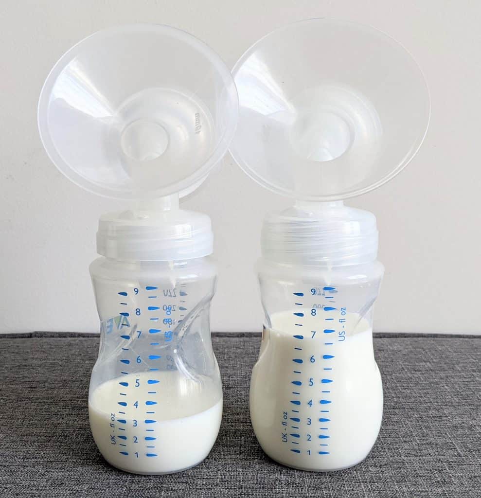 2 breast pump bottles with uneven amount of breast milk showing a slacker boob