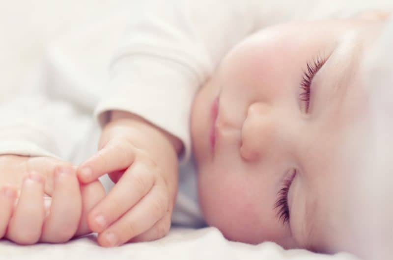 sleeping baby with very long and thick eyelashes