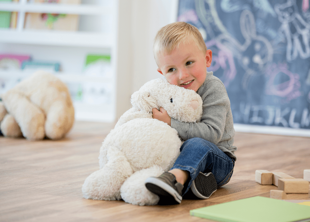 toddler holding stuffed animal