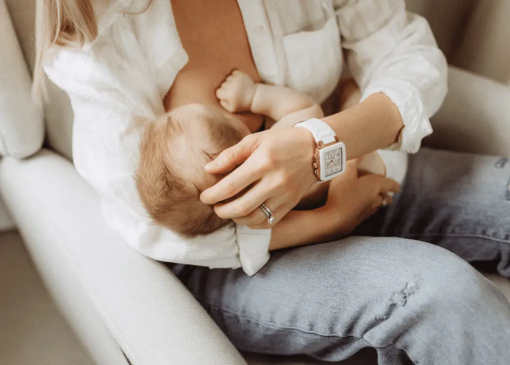 new mom holding baby breastfeeding