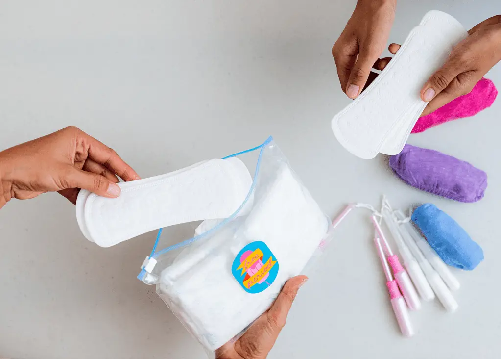 women with various menstrual products, such as pads and tampons