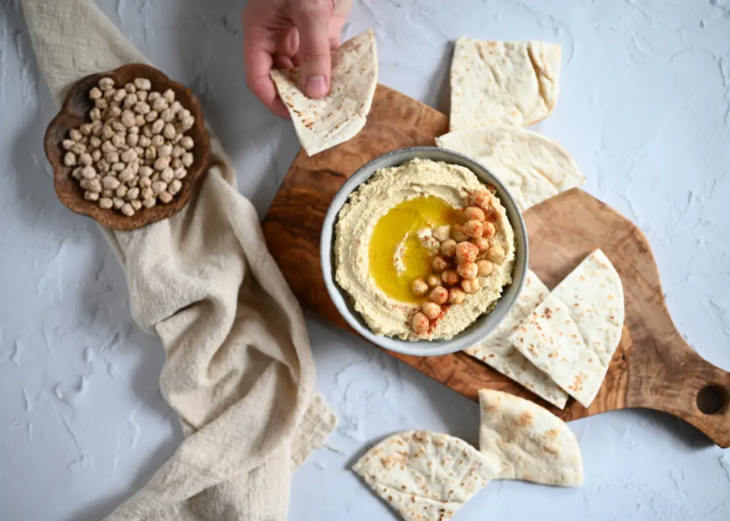 hummus on platter with pita bread for babies to enjoy