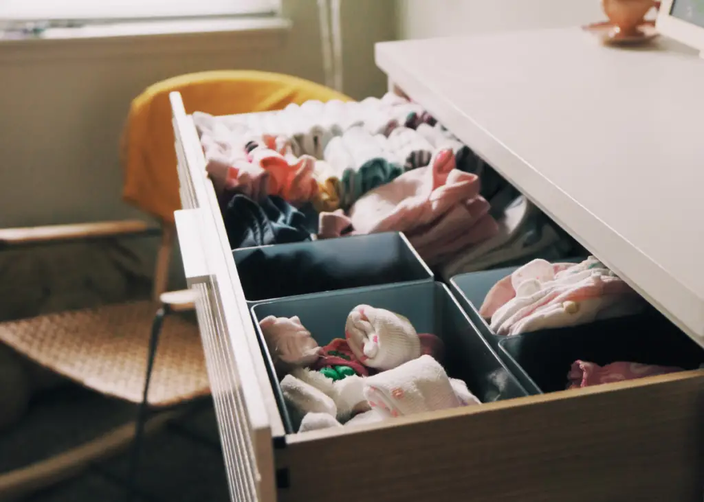 organized baby's drawer with separate bin for socks and mittens