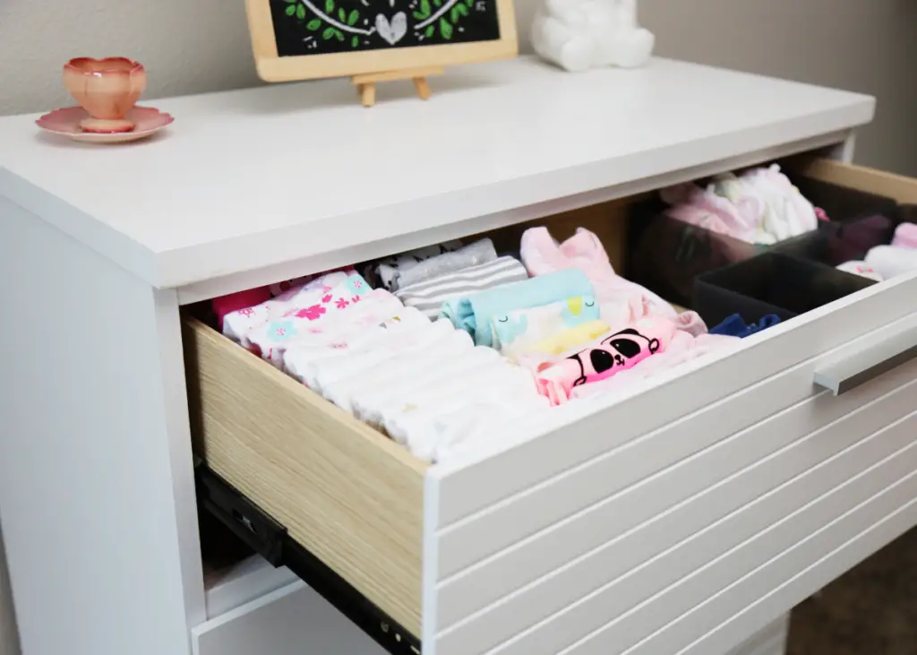 organized baby's drawer with all outfits neatly folded