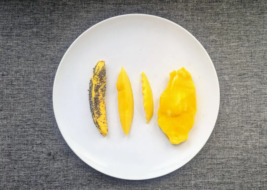 slices of mango cut up different to show how to serve baby mango in baby-led weaning style