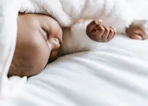 baby sleeping peacefully with warm hands