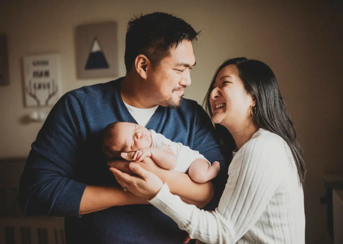 new mom and dad holding newborn baby for newborn photoshoot