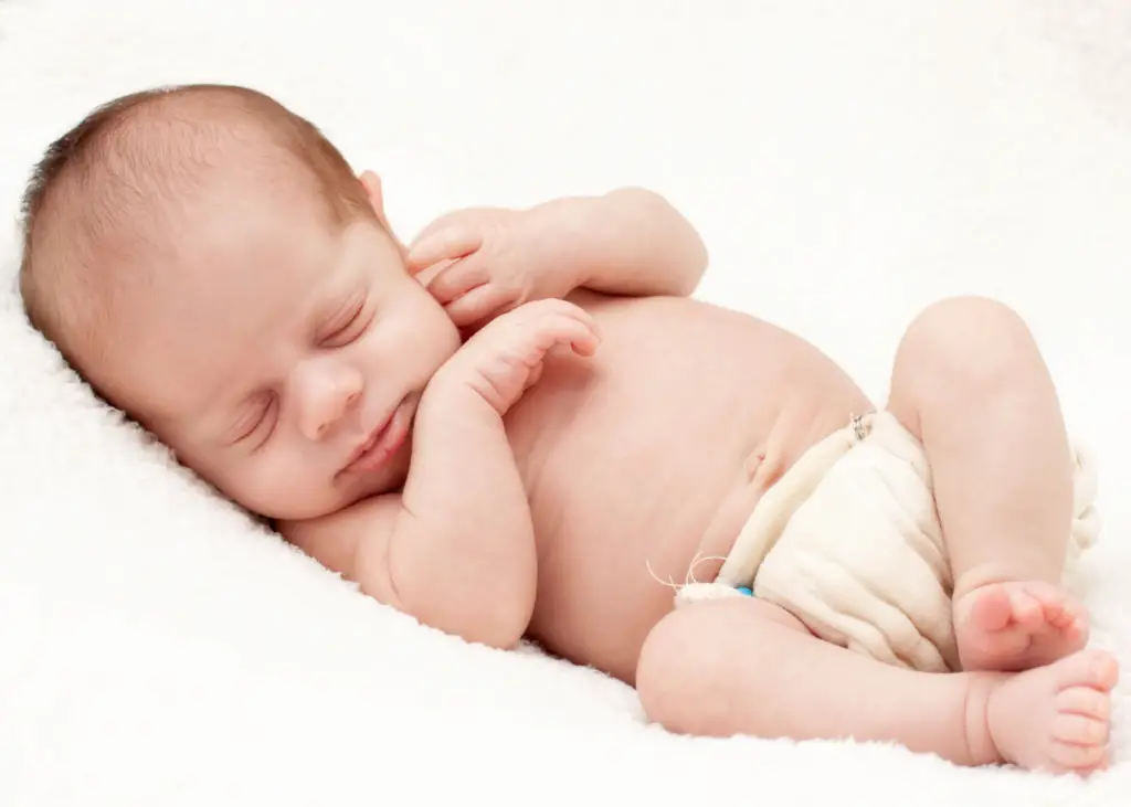 newborn baby sleeping comfortably in overnight cloth diaper