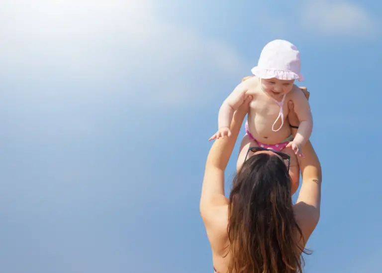 new mom taking her newborn to the beach for things to do in the summer