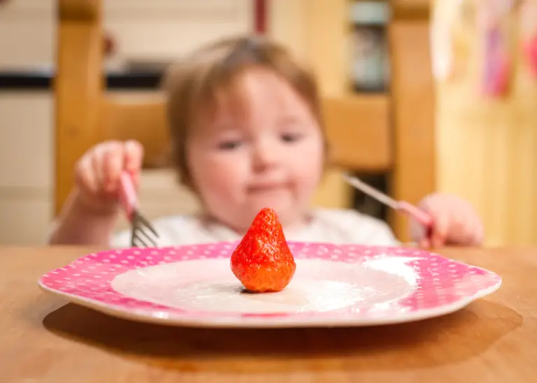 baby wondering how to slice strawberry for baby-led weaning