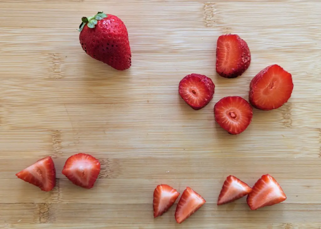 different ways to serve and slice strawberry for baby-led weaning, such as whole, in rounds, halved, or quartered