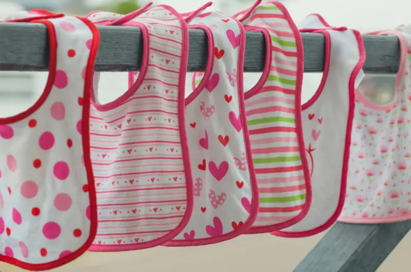 six bibs hanging out to dry with varying patterns